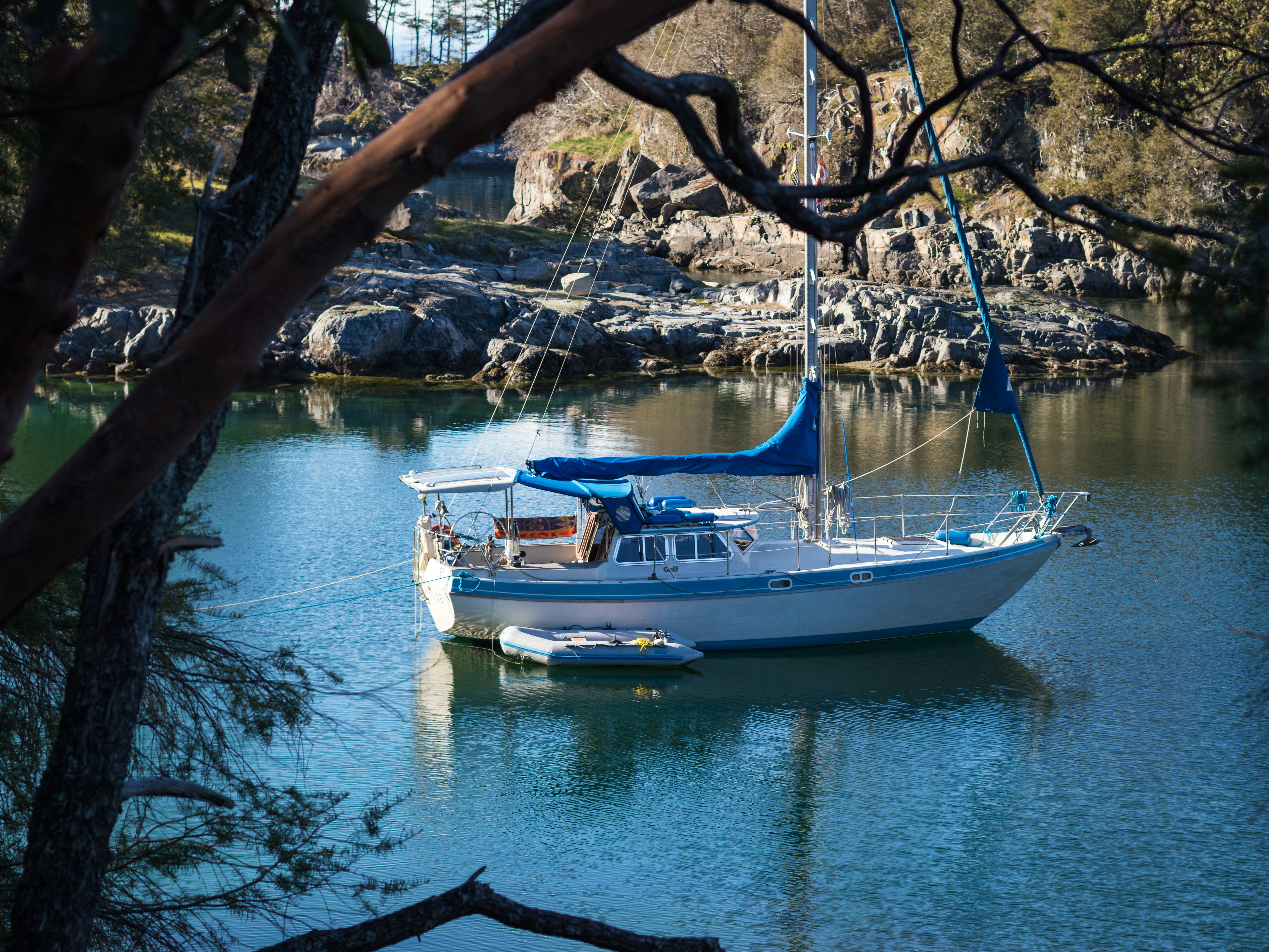 white sailing boat on body of water